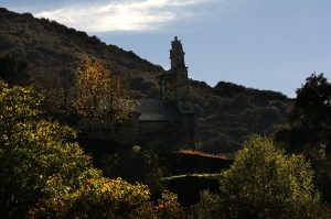 La Iglesia de San Vicente con una contundente respuesta otoñal de su entorno en Arganza, El Bierzo, León, Castilla y León, España.